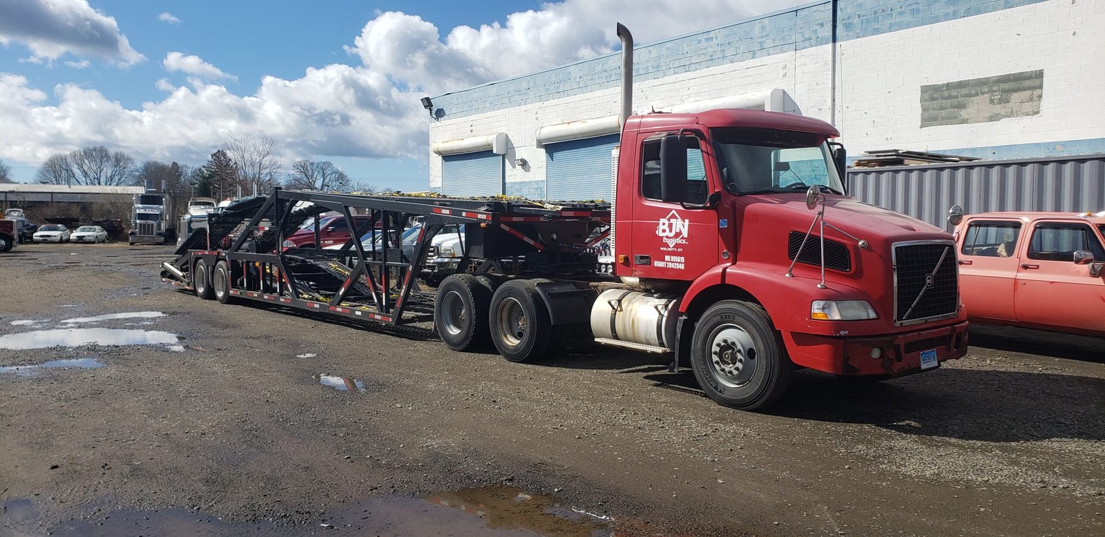 Commercial car hauler fleet truck with custom vinyl door graphics